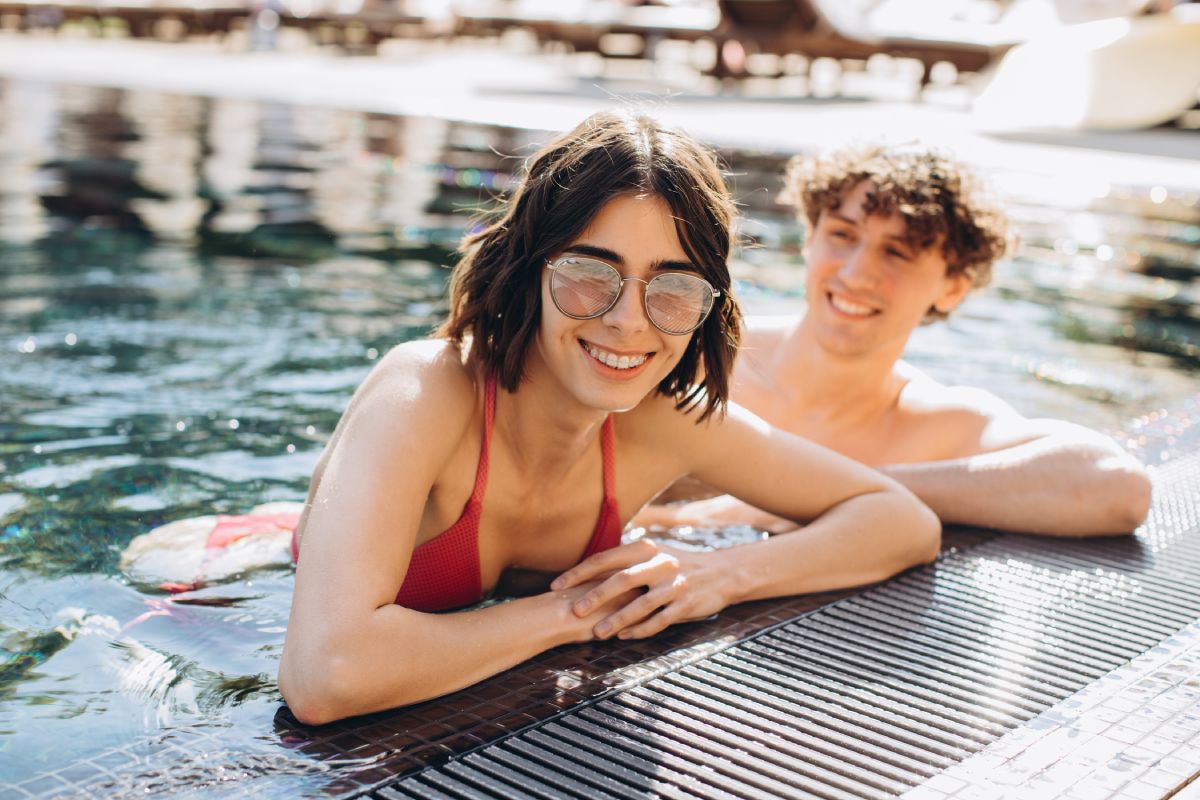 Portrait of an attractive young couple relaxing in a pool.