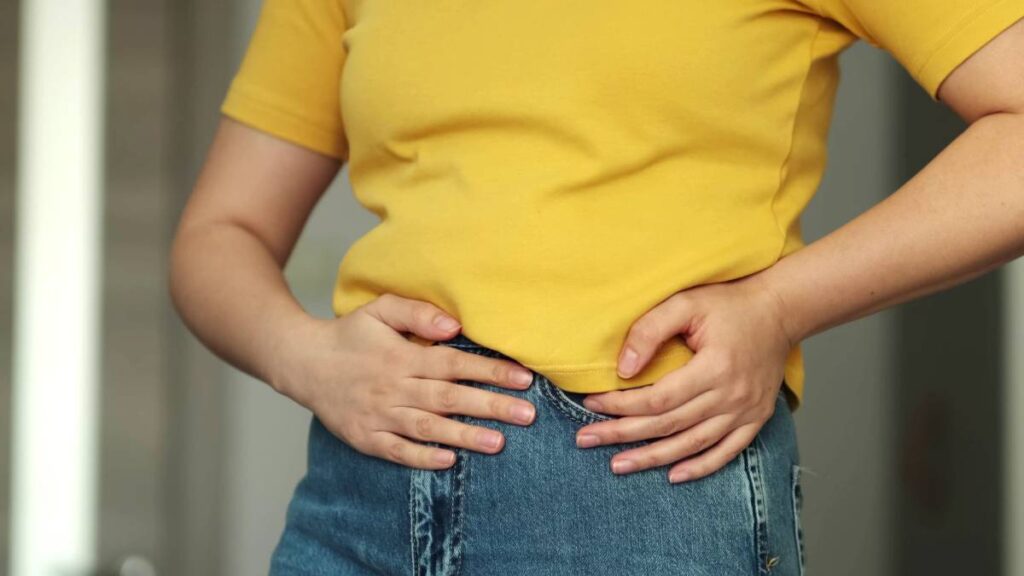 Woman touching his stomach. Stomach pain and others stomach disease concept.Girl having a stomachache. Young woman suffering from abdominal pain. Woman Stomach Ache