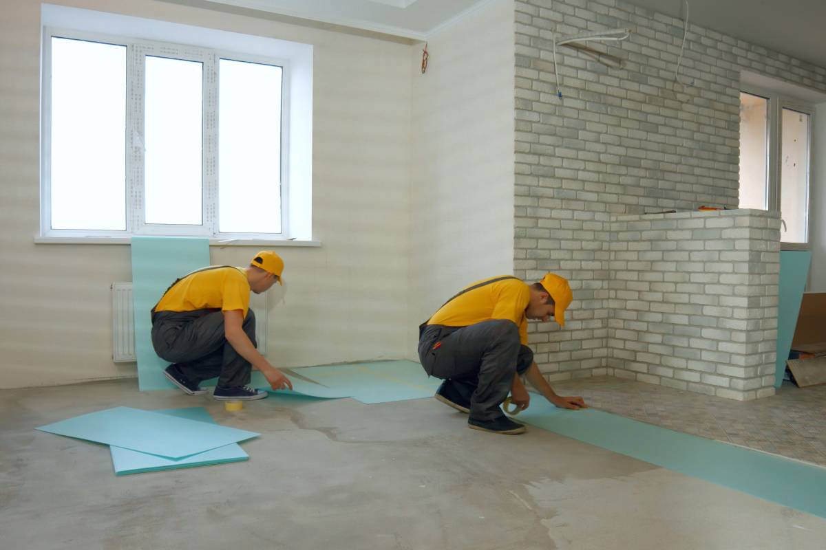 Builders insulating floor in a large house. Thermal insulation of the floor in the apartment. Building and home renovation.